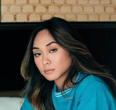 Woman in blue top indoors